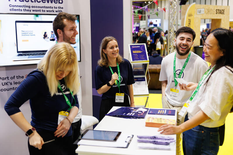 A group of people engaged in conversation around a table at an event, showcasing interaction and networking.
